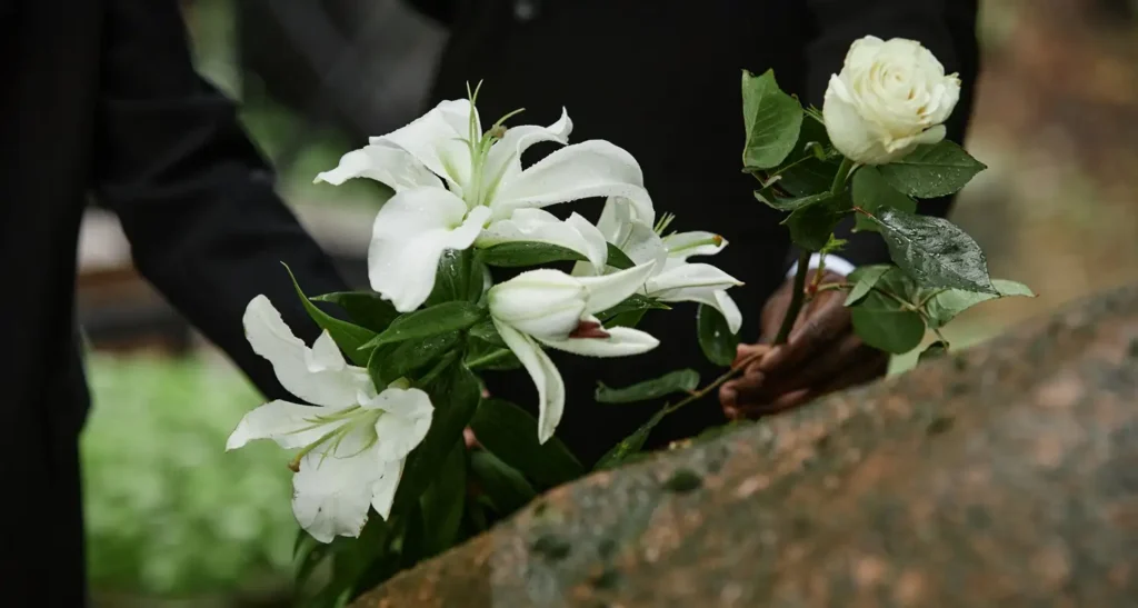 People laying white lilies
